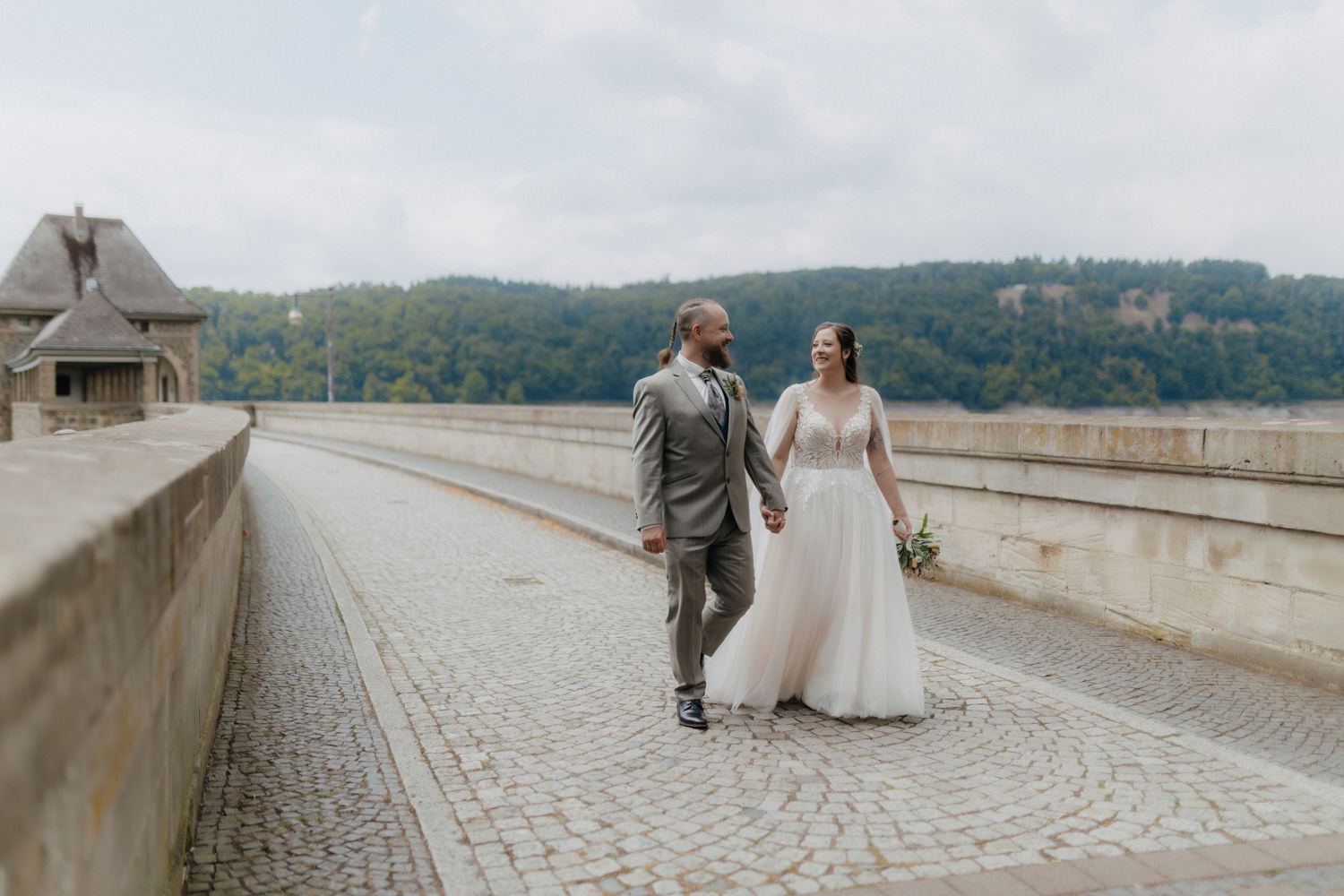 Brautpaar spaziert Hand in Hand am Edersee Hochzeitspaar