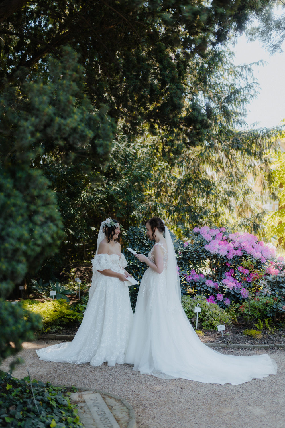 Zwei Bräute lesen persönliche Worte, freie Trauung im Park Bonn